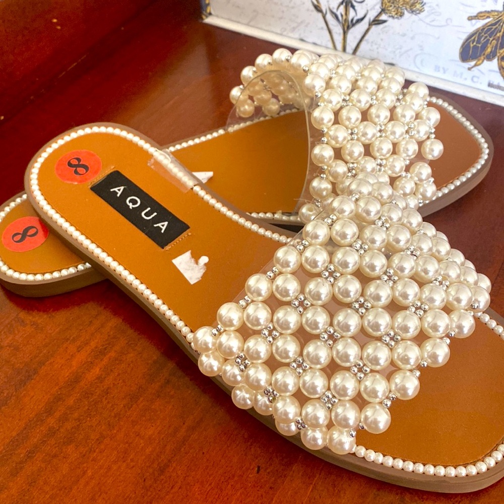 Flat slide sandals with faux pearl embellishment
Slip-on style
.75 inch heel